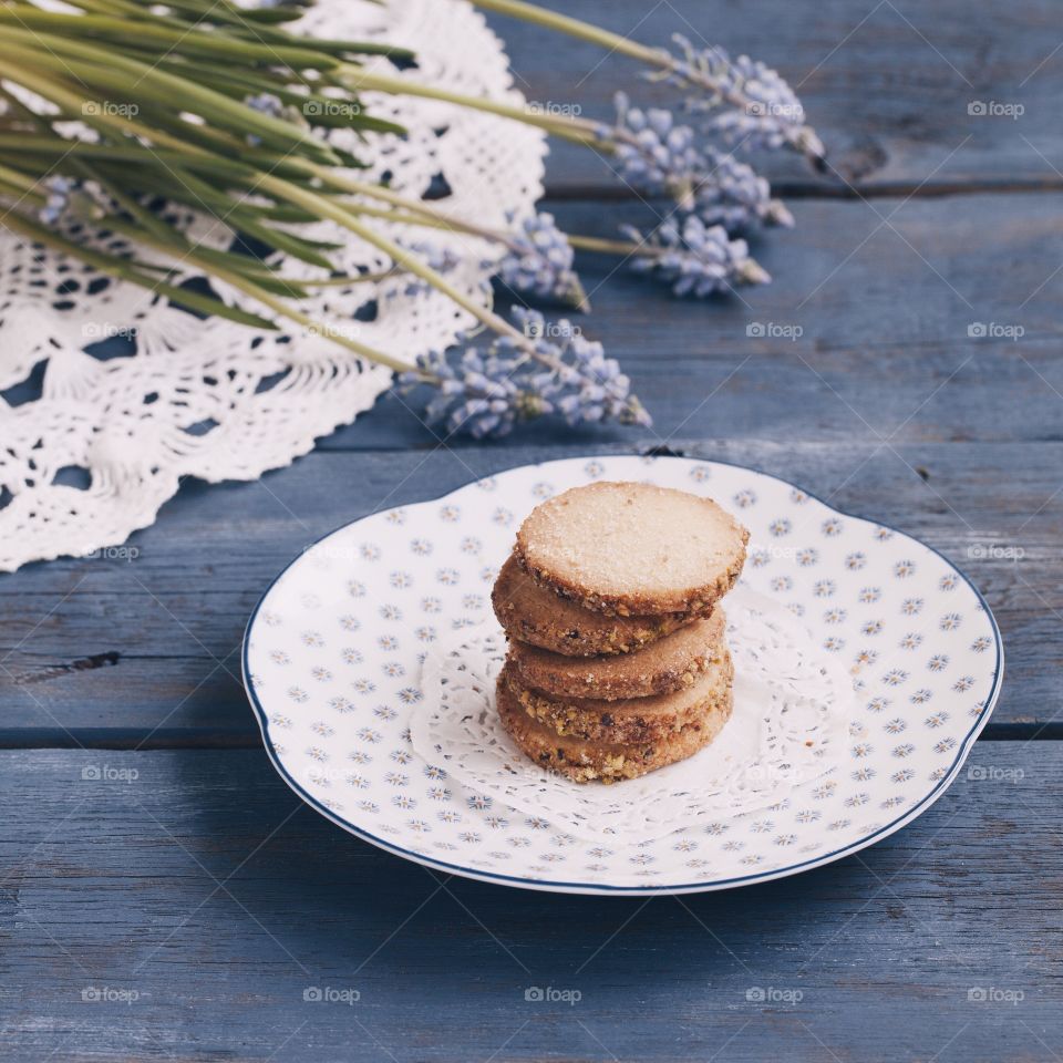 Cookies and flowers on the wooden table 