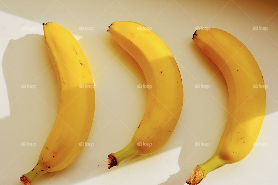 bananas top view on a white fruits background