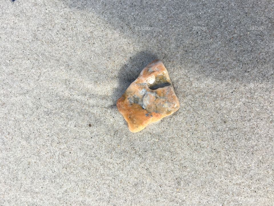 Orange stone on beach 
