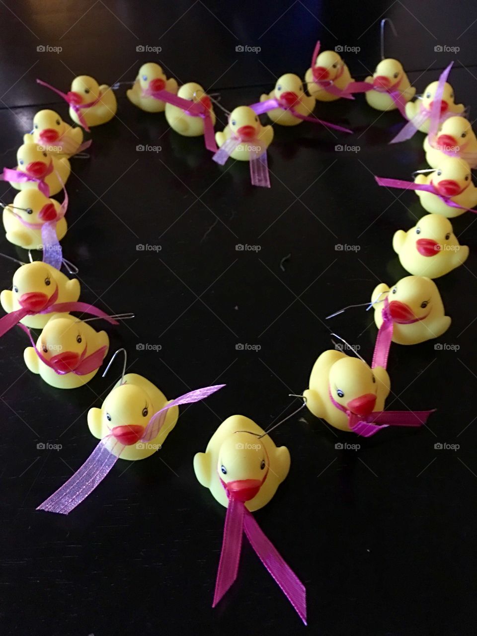 Yellow ducks with breast cancer awareness . 