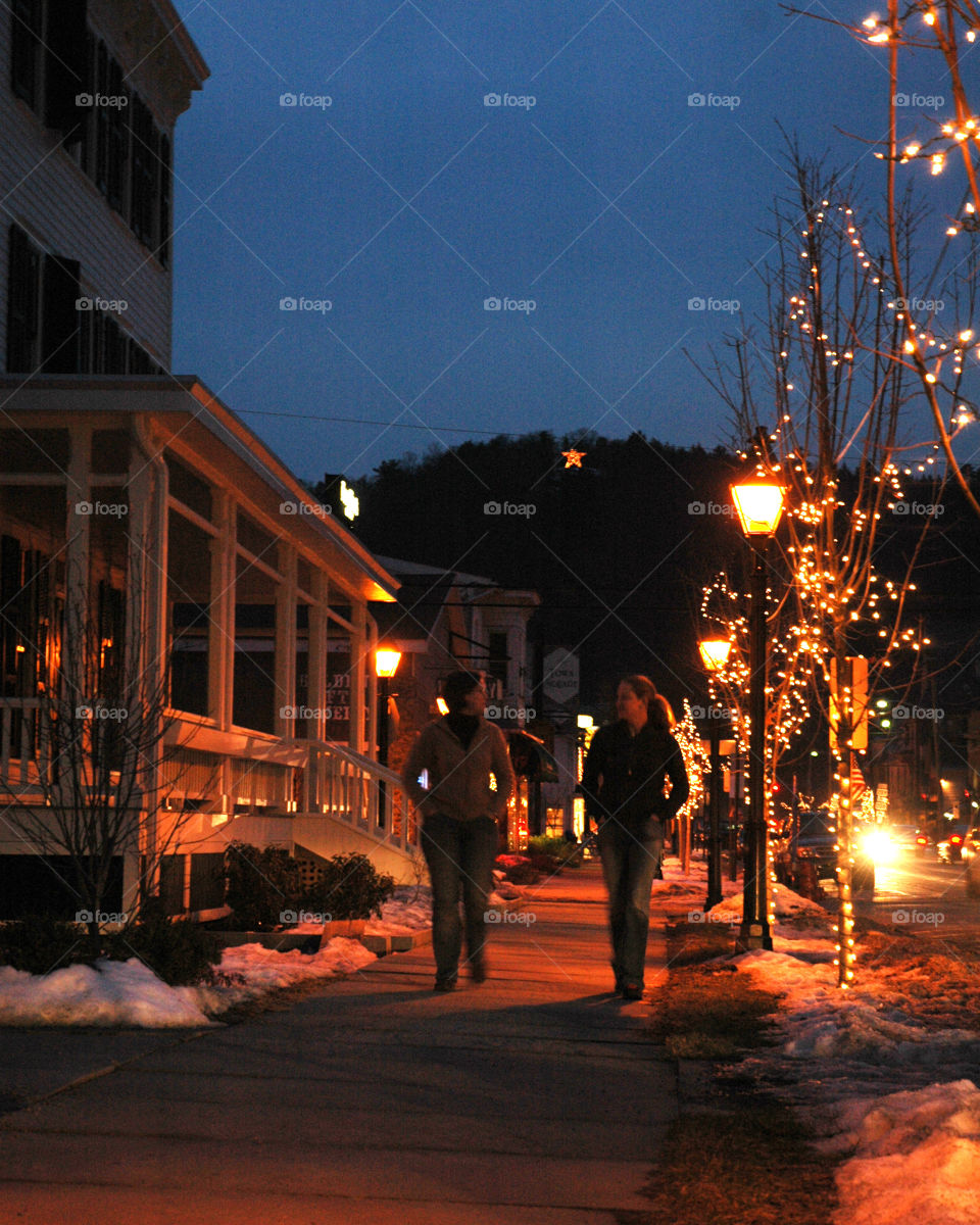 Holiday shopping on main street at night, mountain town, star on the hill