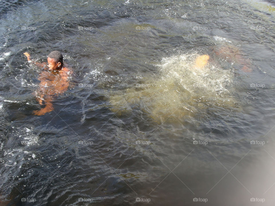Boy Swimming In River