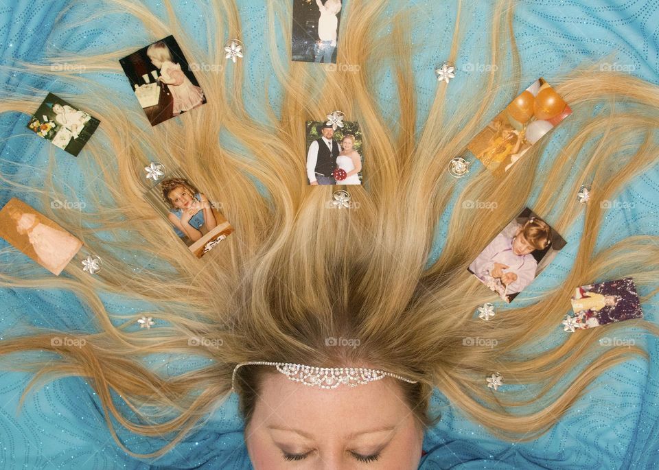 Woman with pictures of herself at different ages in her hair