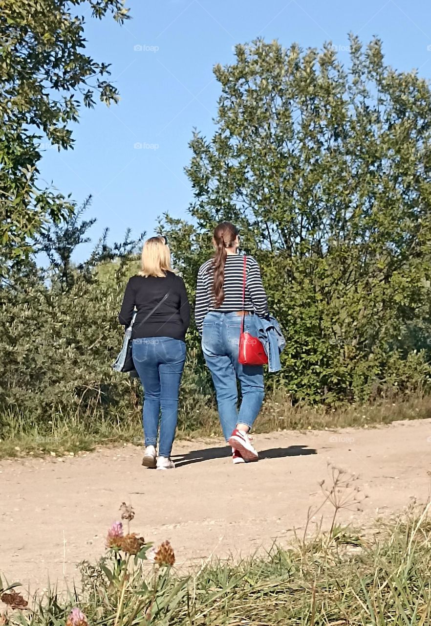 two womens friends walking outside