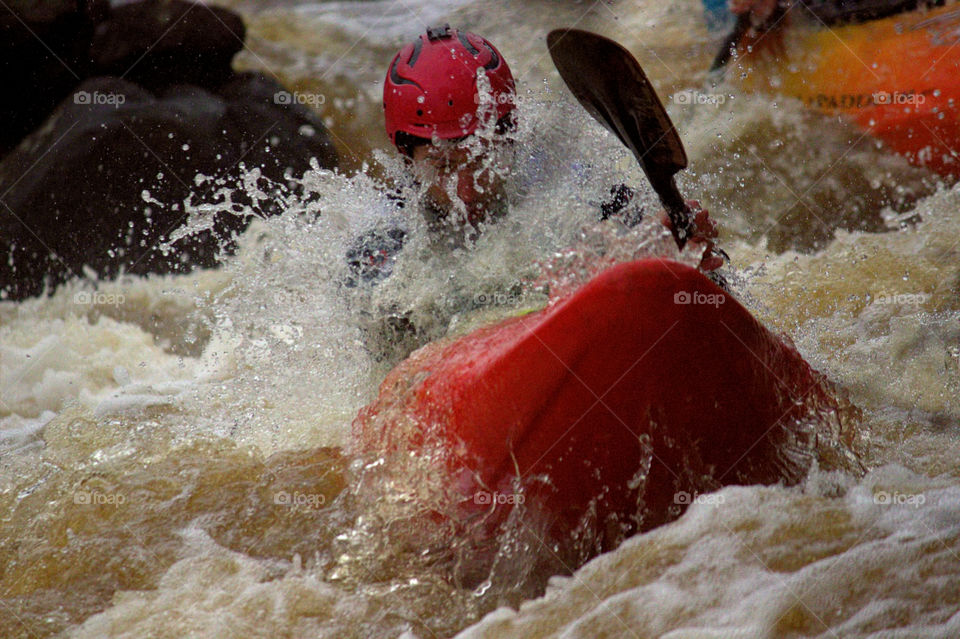 Helsinki, Finland - April 17, 2016: Unidentified racer at the annual iceBREAK whitewater kayaking competition at the Vanhankaupunginkoski rapids in Helsinki, Finland.