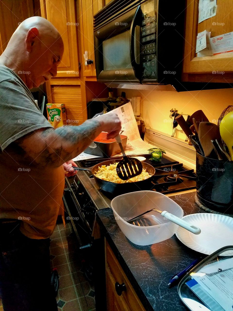 Husband cooking dinner for wife.