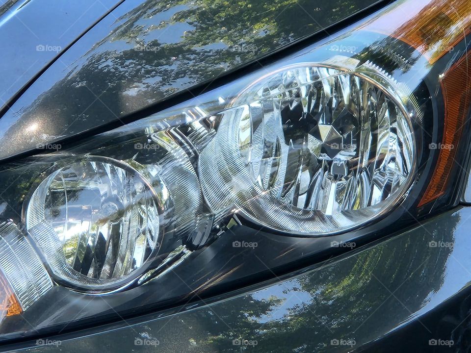 close up of shiny modern car headlights reflecting