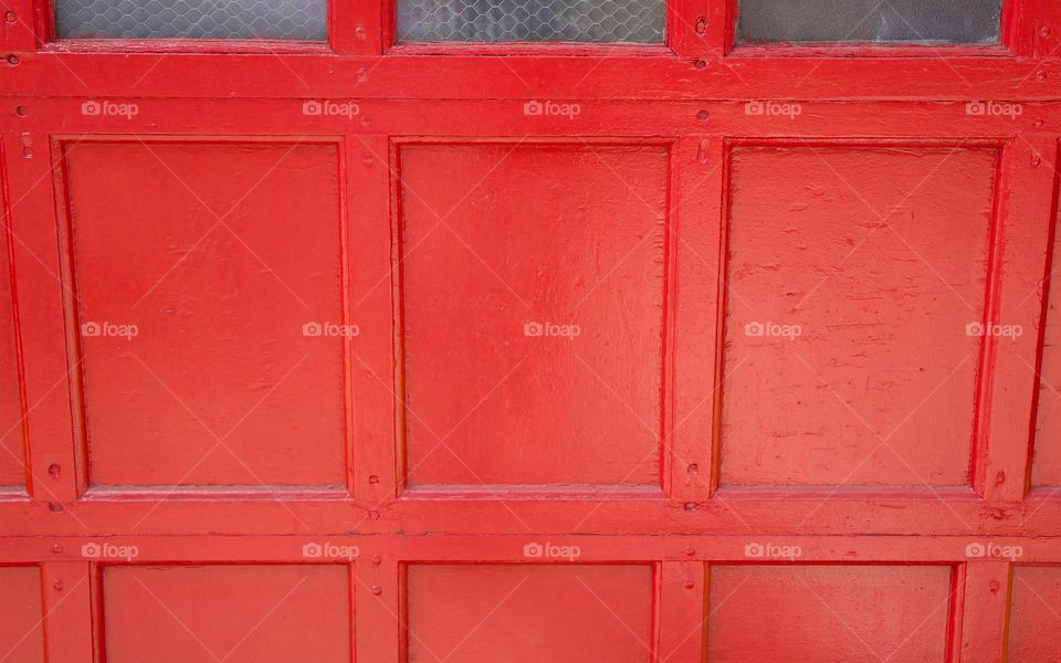  Bright red closeup of residential garage door in New York City. 