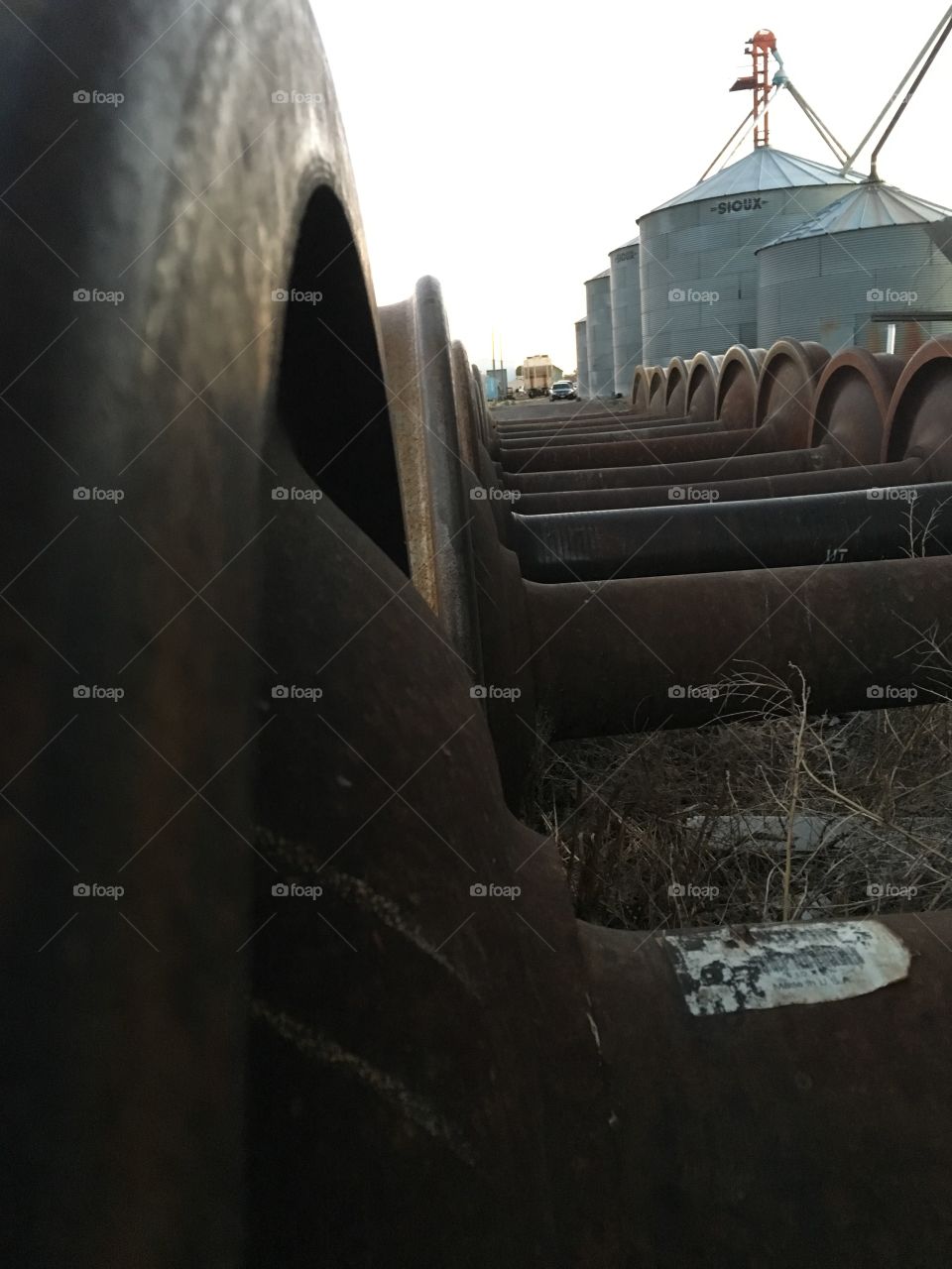 Several old wheels abandoned near grain silos