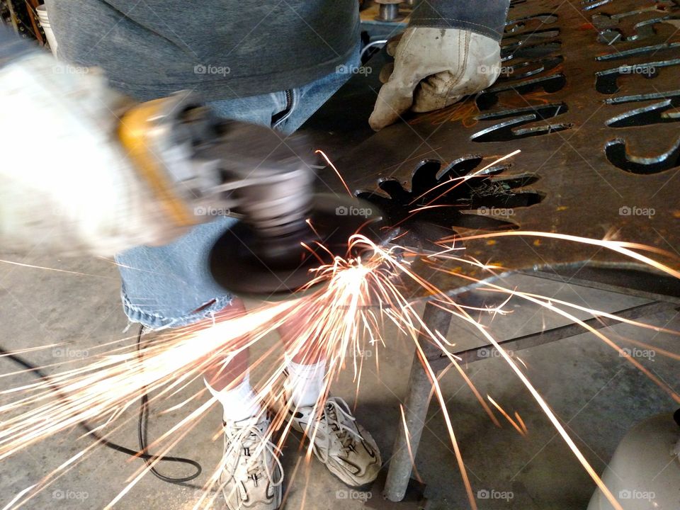 A Welder Crafting A Metal Garden Sign