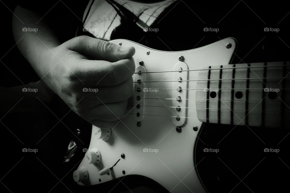 Man Playing an Electric Guitar in black & white