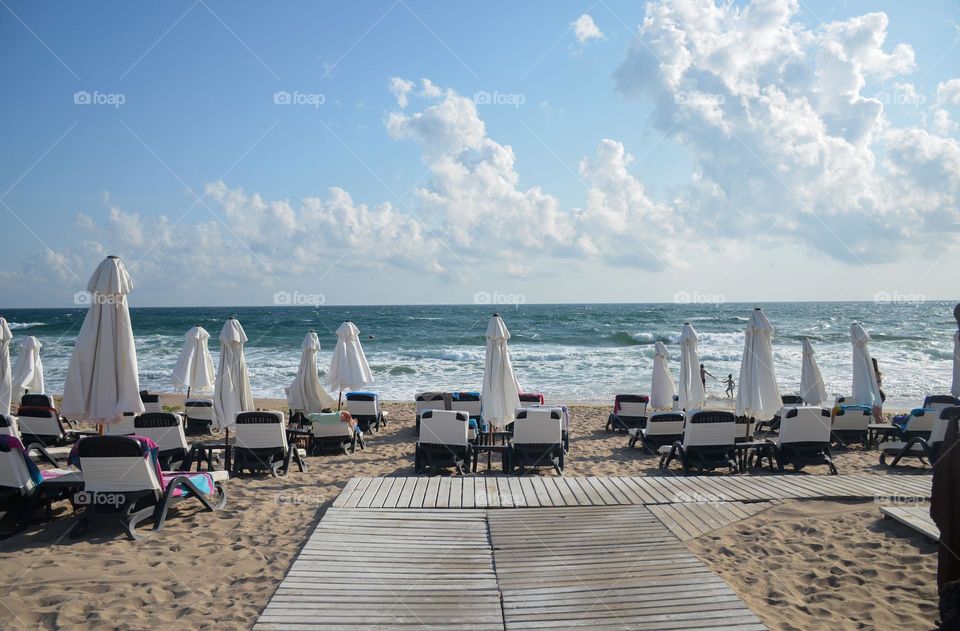 On the beach, repetition sunbeds and umbrellas