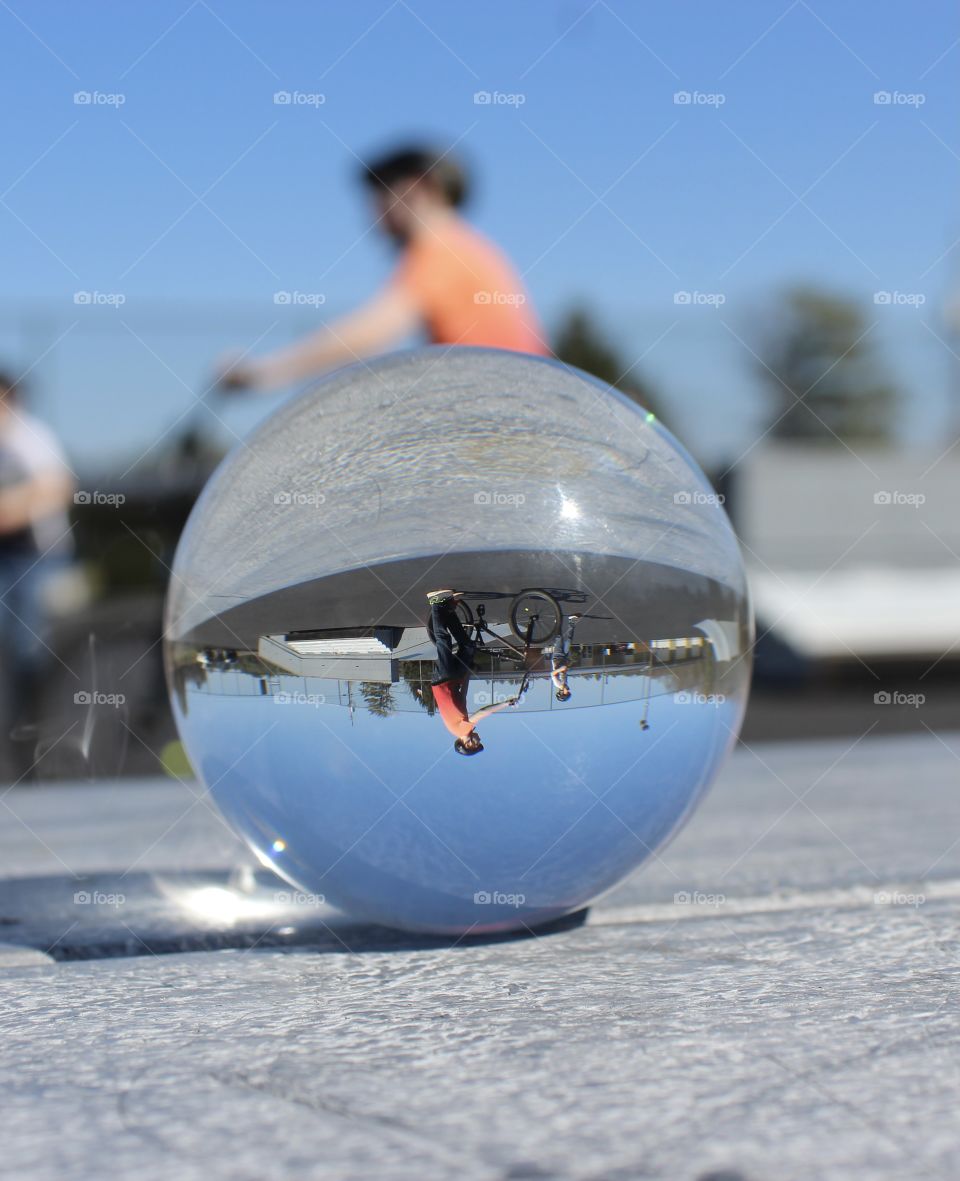 Boy riding bike through Glass Globe