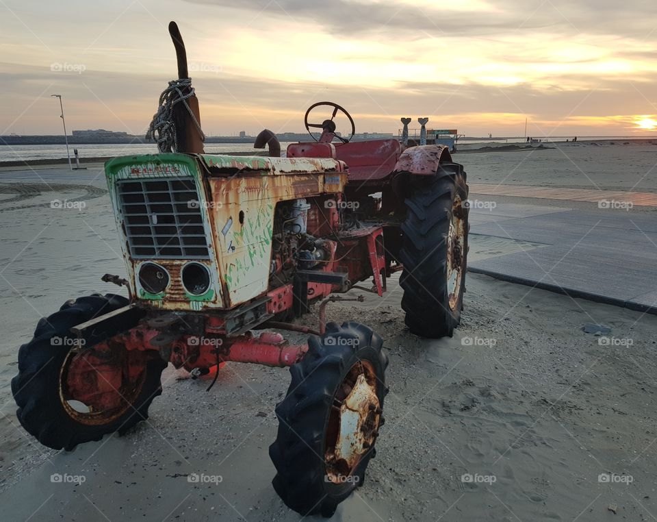 Side view tractor sunset