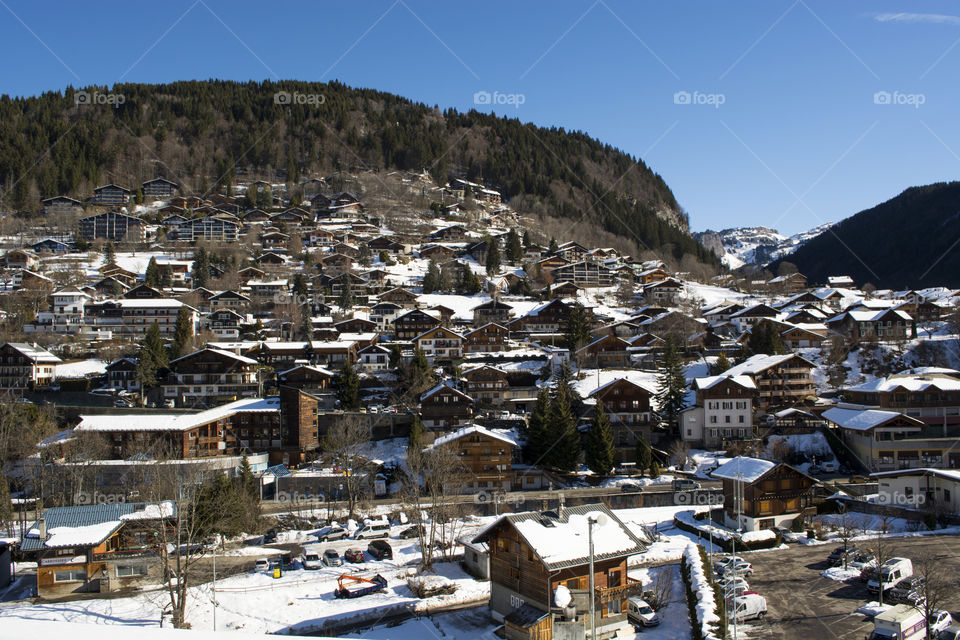 Wooden houses in the alps covered with snow