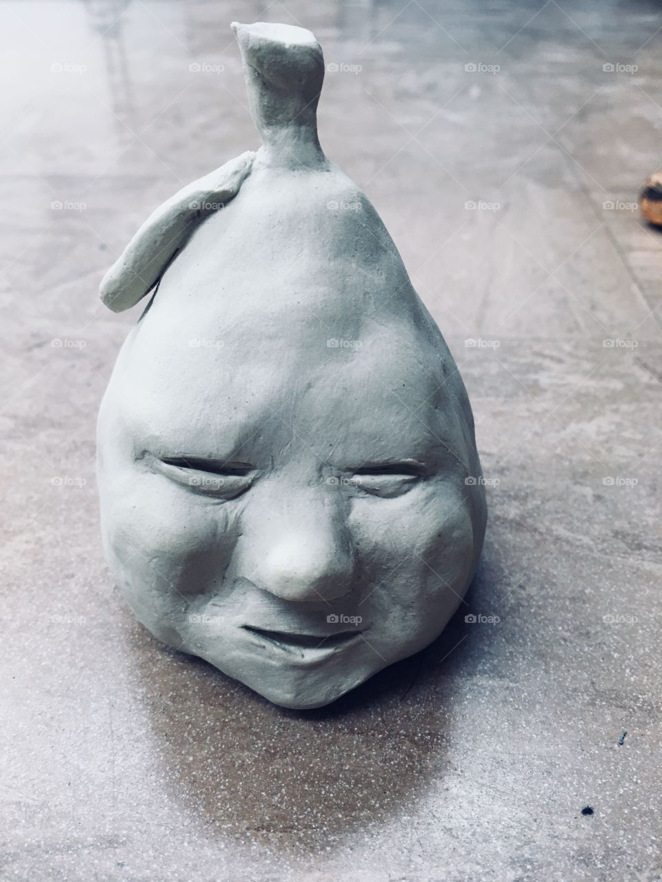 Pear with face sculpture 