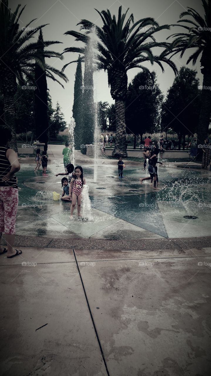 Group of children enjoying at fountain