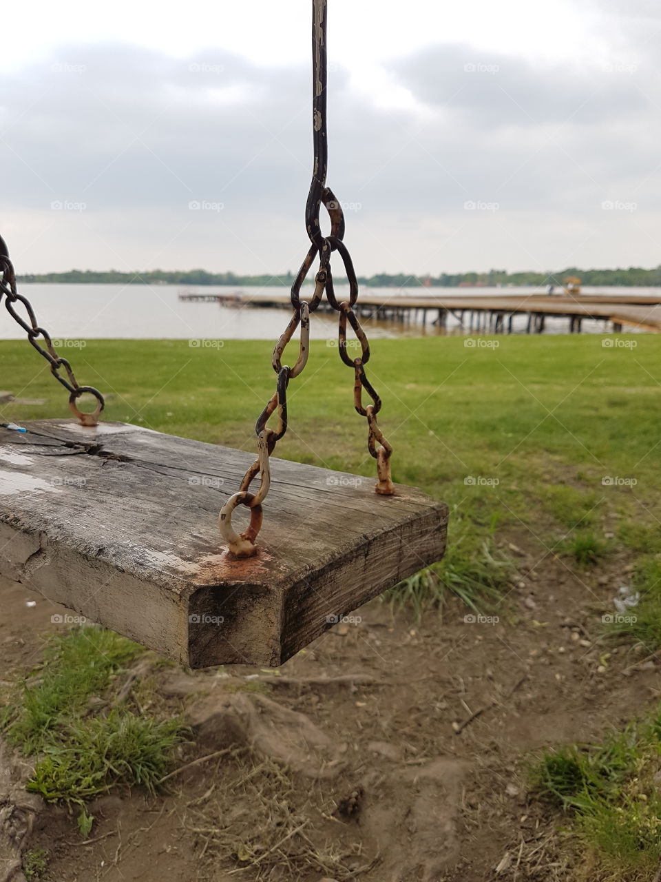 Old swing besides lake