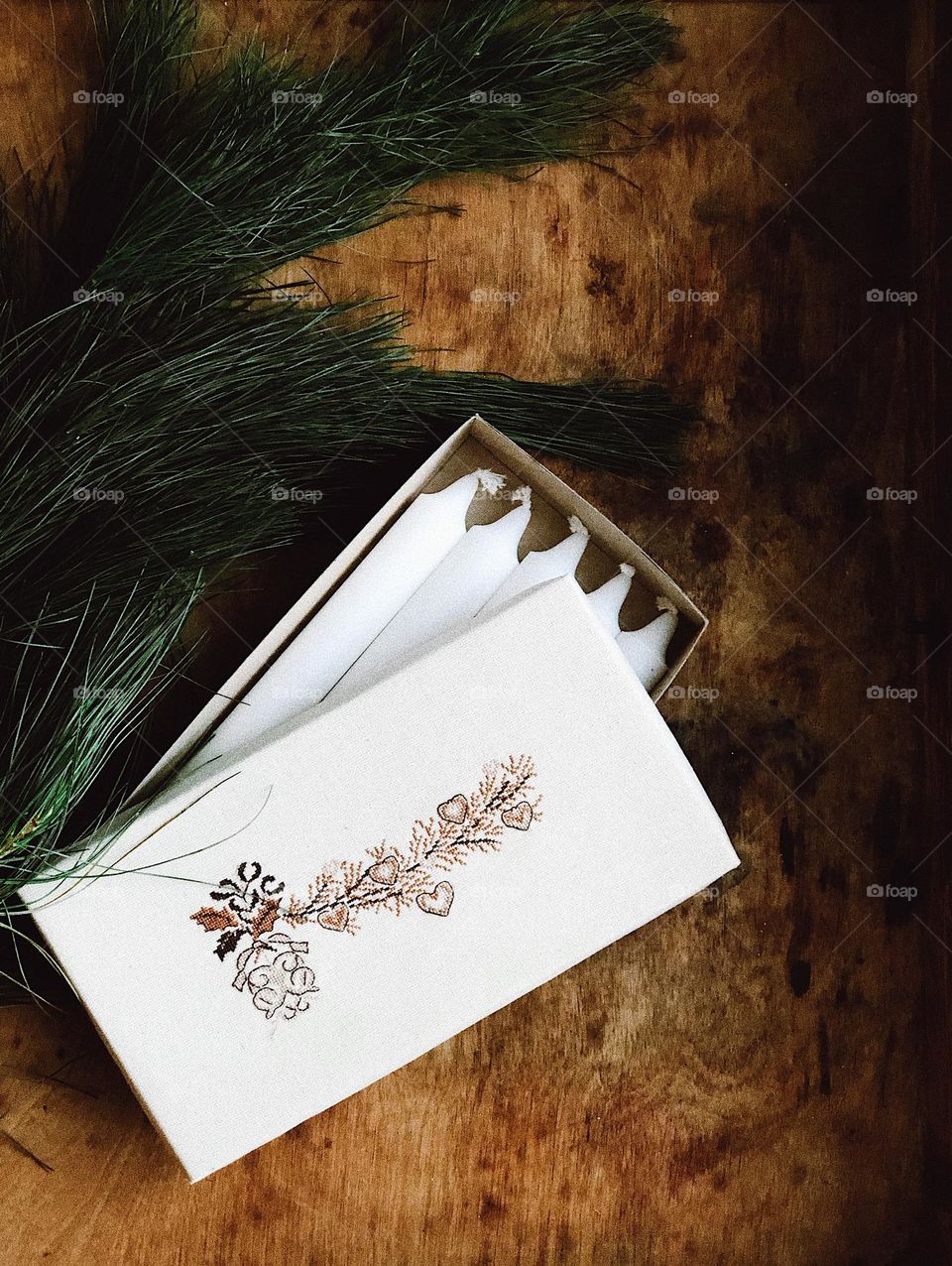 Christmas box with candles on a wooden table 