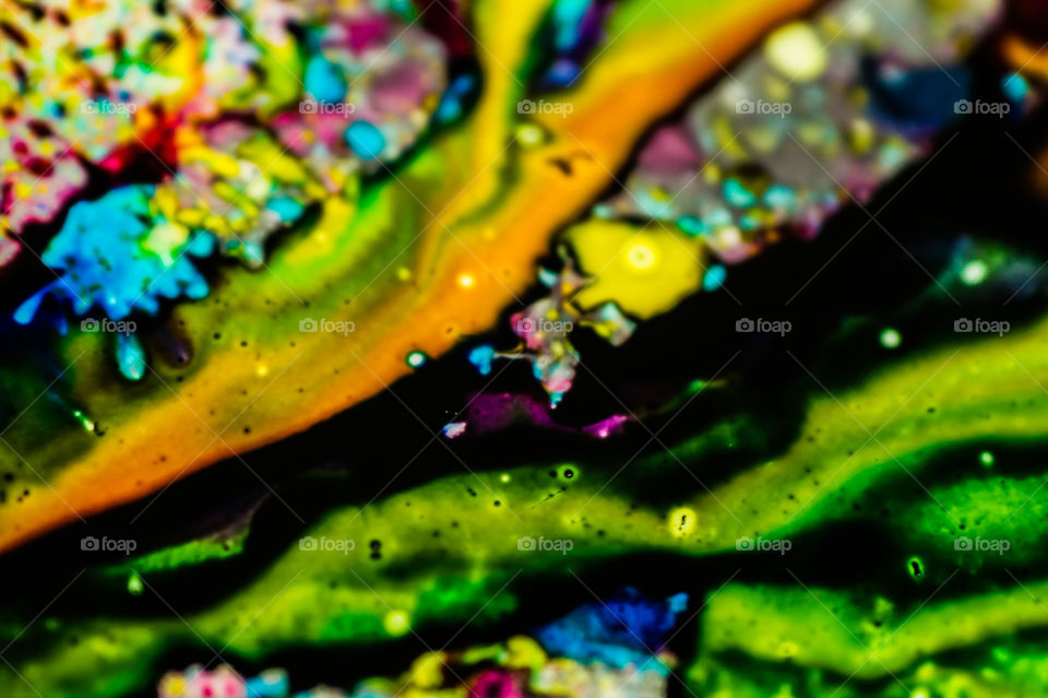 The ink to refill the printer cartridge was spilled onto the white washbasin and the paints blended into abstract drips and patterns.