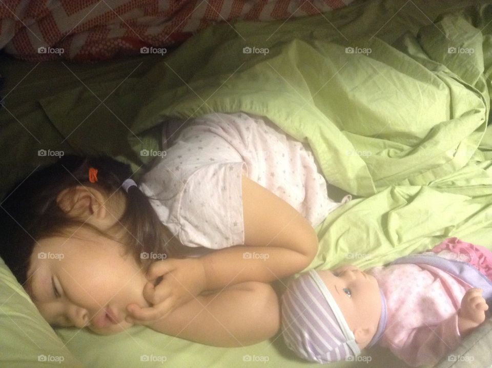 Baby kid lying on bed with sister