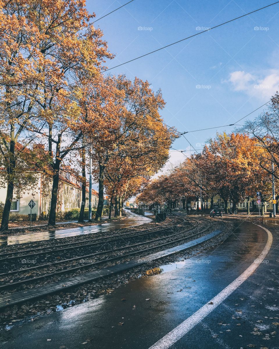 Railroad tracks by road against sky