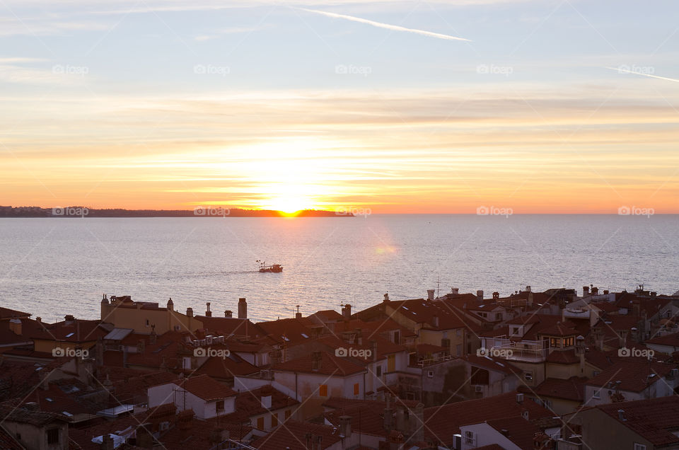 Beautiful background of the Adriatic seaside in Slovenia against the orange sunset sky. Natural backgrounds and textures. Travel conception.