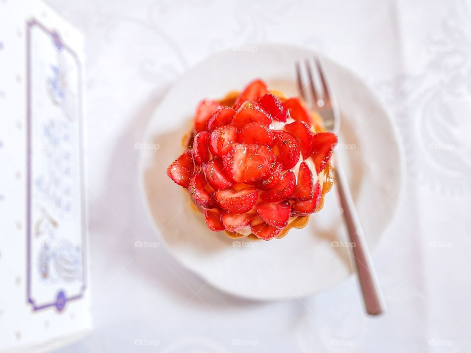 Delicious tart with vanilla cream and fresh strawberries fruits is a perfect summer dessert.