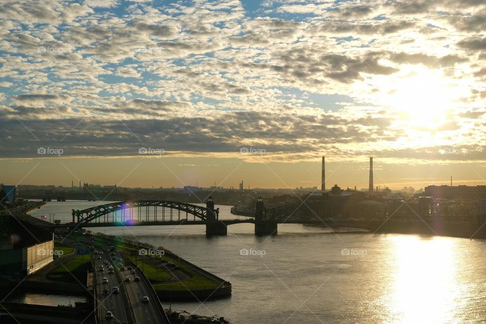 View of the city, the bend of the river and bridge at sunset