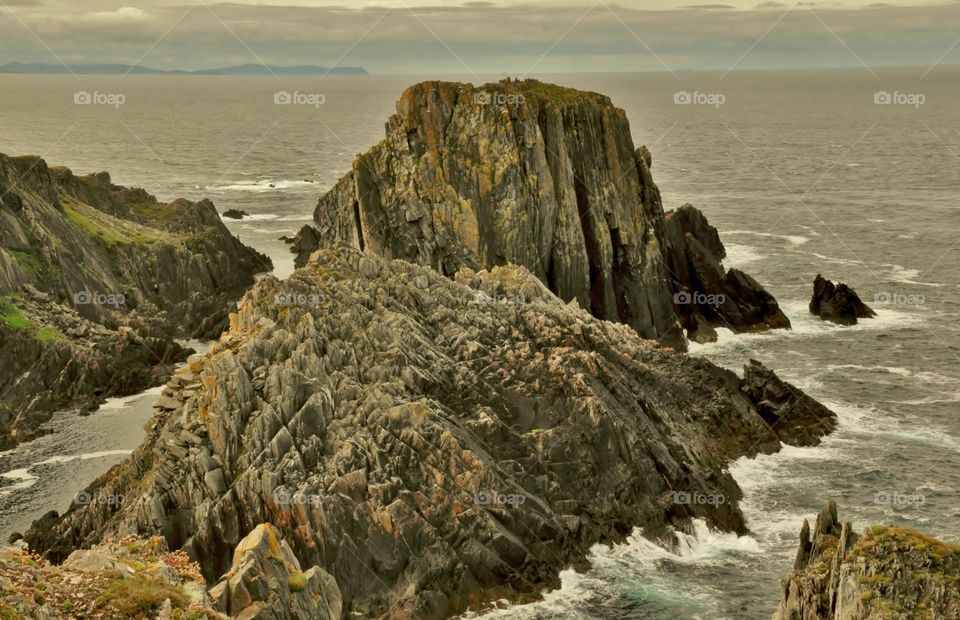 View out over jagged rock formations to the ocean