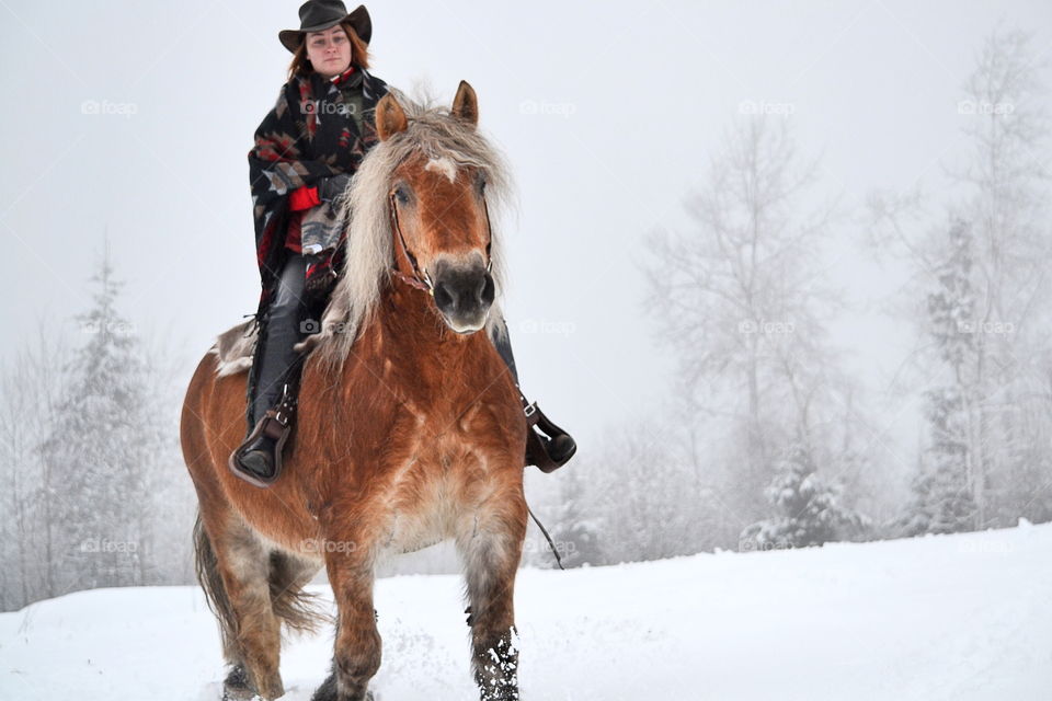 Young woman riding horse