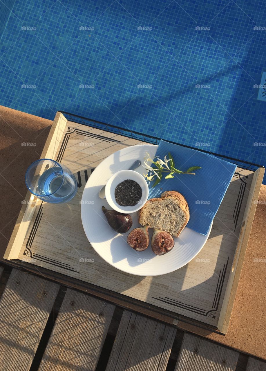 Flat lay of healthy snack tray near the pool