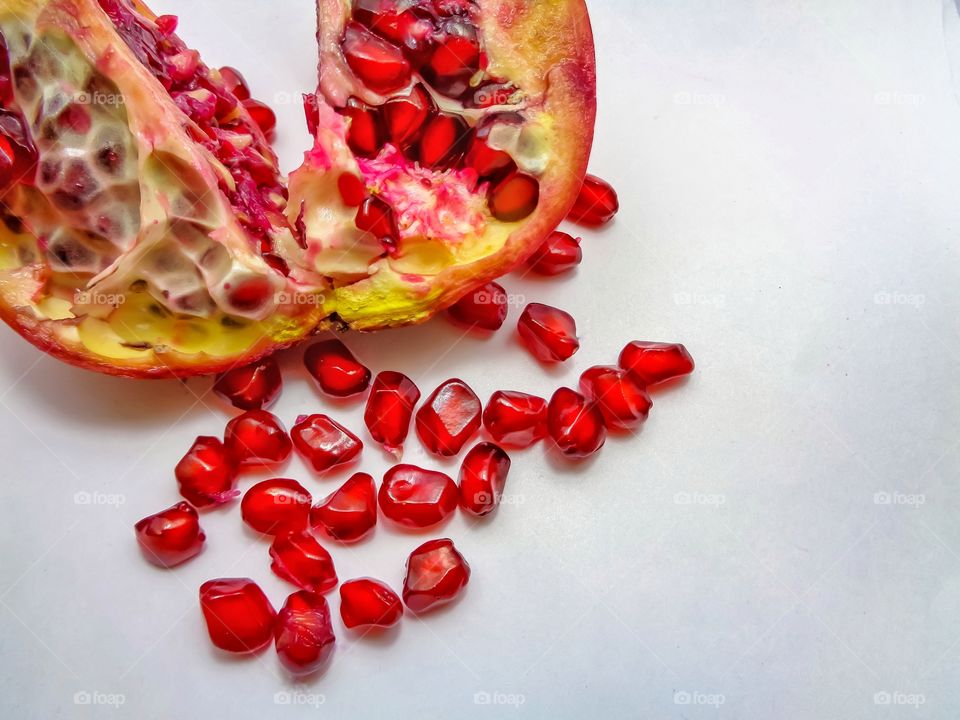 Red pomegranate on white background.