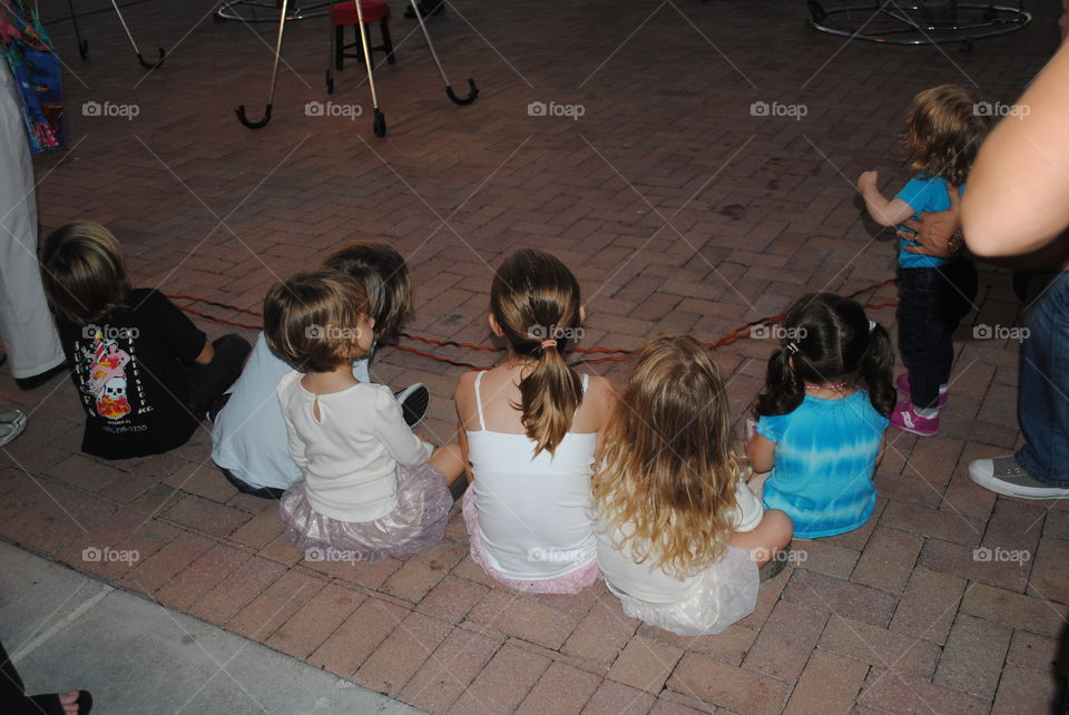 Kids watching a show at Mallory square in Key West, Florida