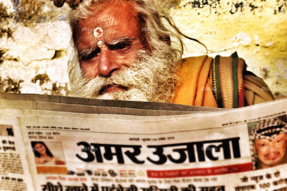 Indian man reads the morning news paper . Indian man reads the morning news 