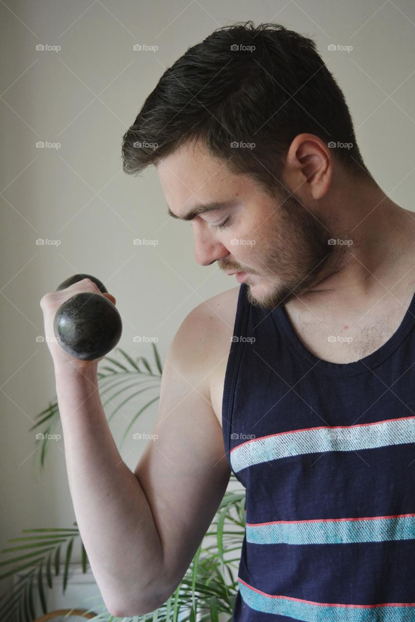 men training indoor, dumbbell in the hand