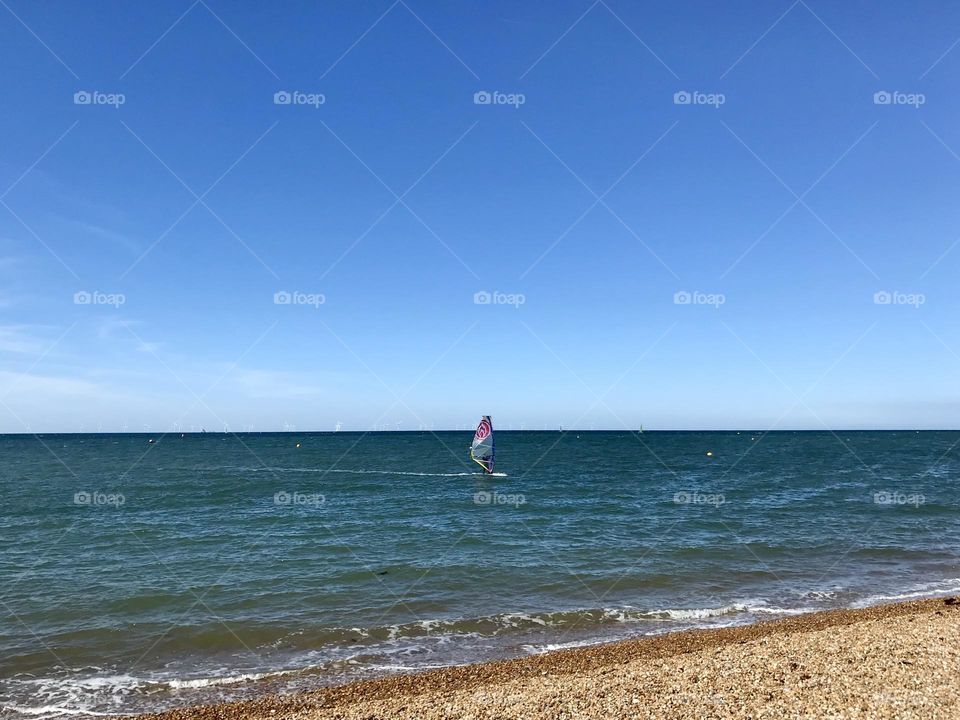 Summer windsurfing off Whitstable beach, United Kingdom