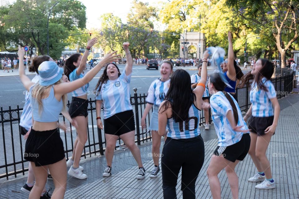 Buenos-Aires - 18.12.2022: Football fans of national team of Argentina in t-shirts on national team celebrating victory on the streets