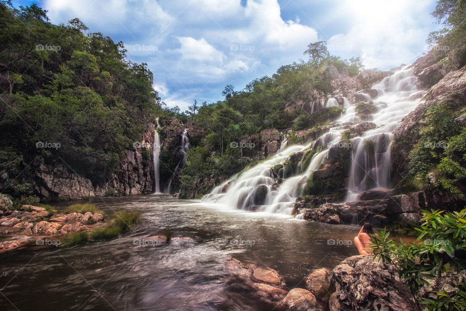 Girl looking at the waterfall