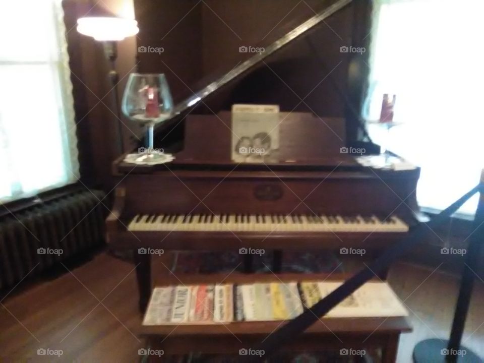 An antique piano at a historic house I visited.