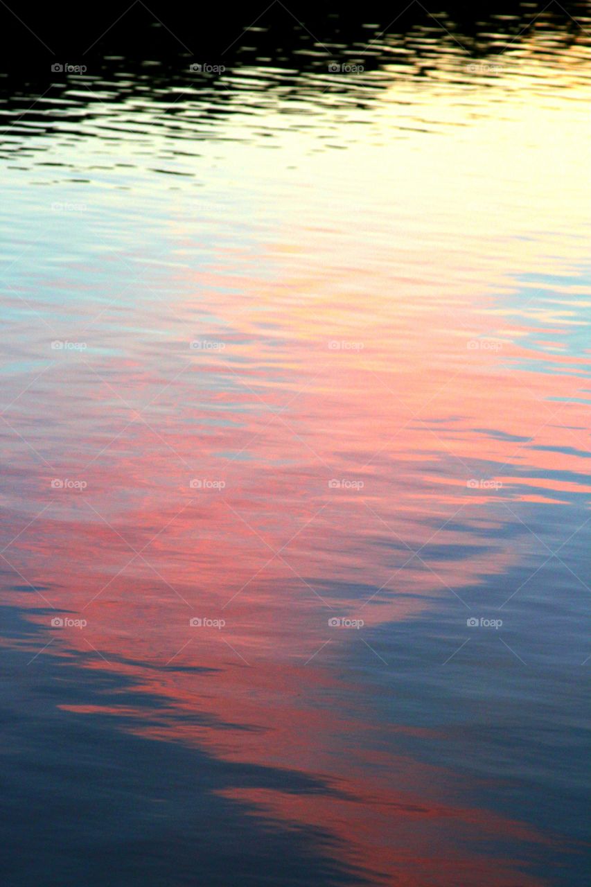 reflections of the sky looking like a pink oilslick.