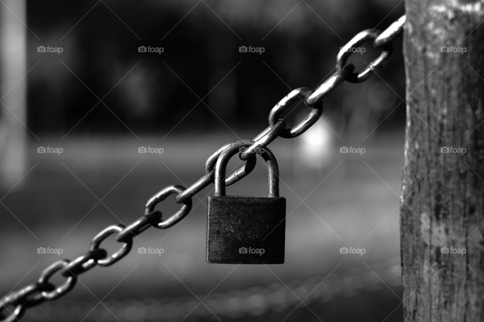 Padlock hanging on chains