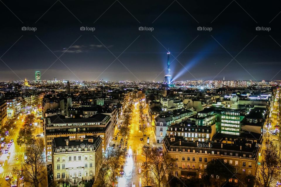 The City of Light from the top of the Arc de Triomphe. The Eiffel Tower stands tall over the the Seine. 