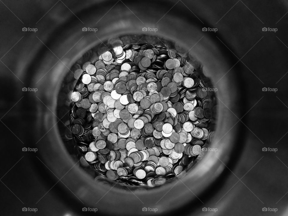 Black and white image of pennies in a jar 