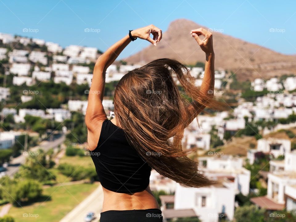 Young woman with long hair in old town 