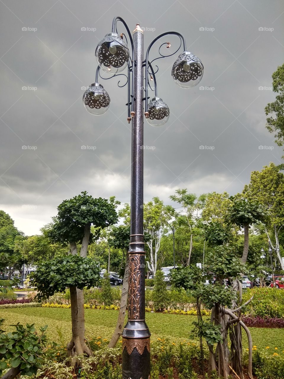 Beautiful park lamps with cloudy sky background