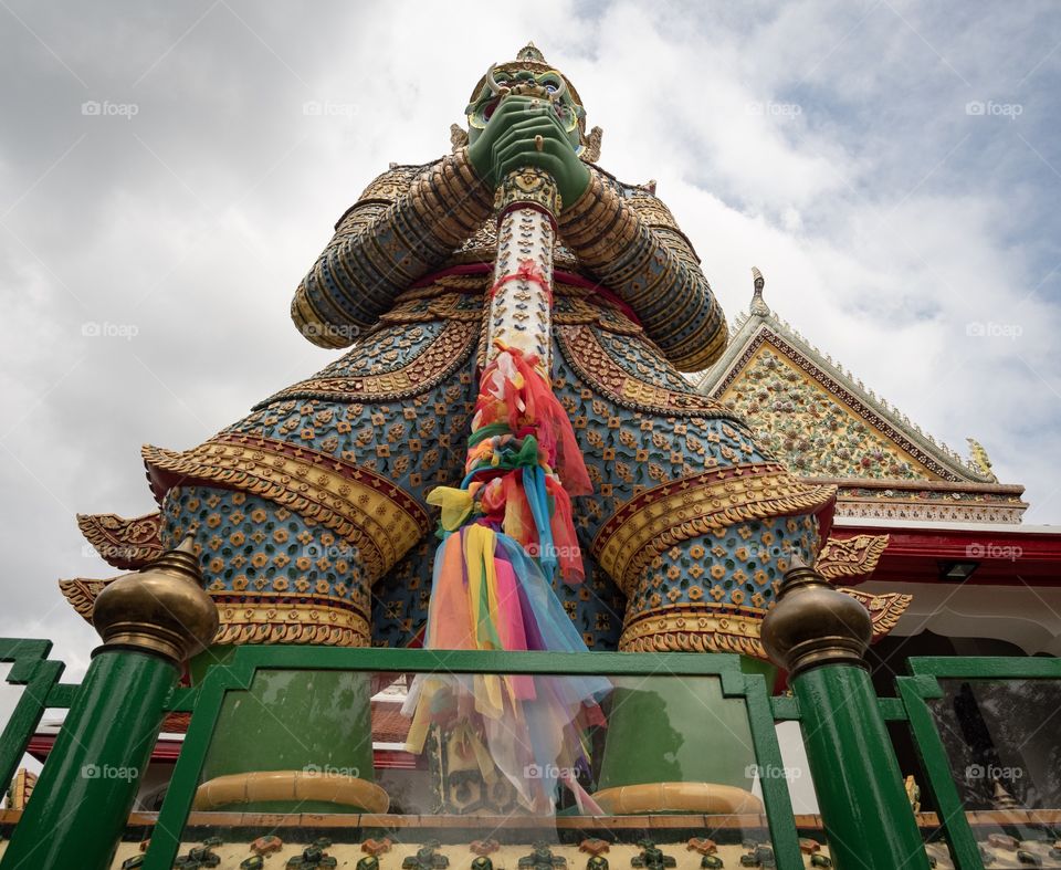 The famous Giant statue of Wat Chaeng (Wat Arun) in Bangkok Thailand is the favorite art for tourists    