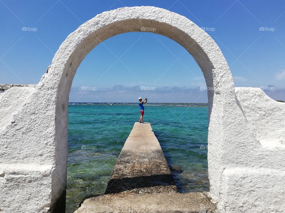 Tourist on the pier takes pictures of the panorama