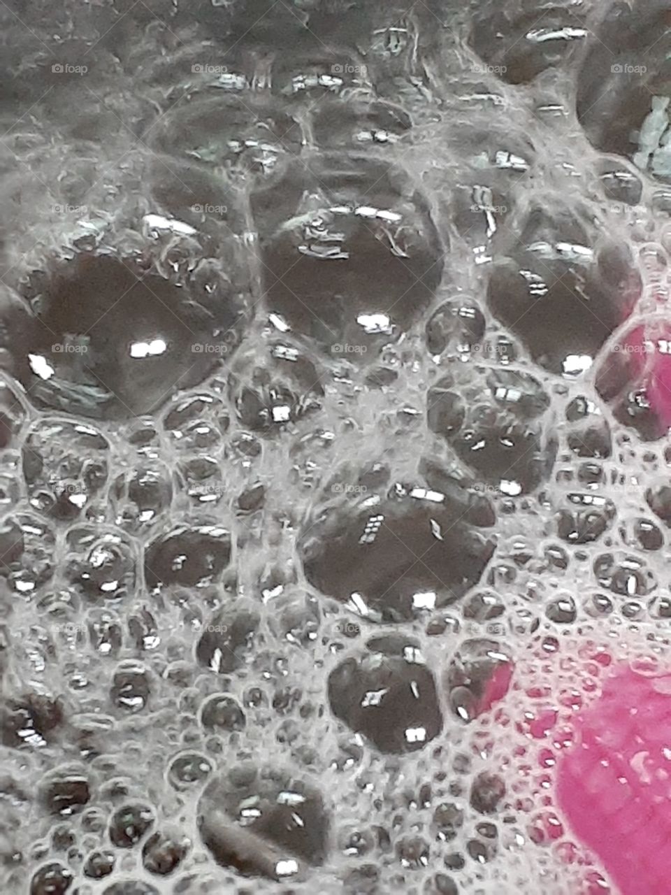 A soap  bubble above  the water level