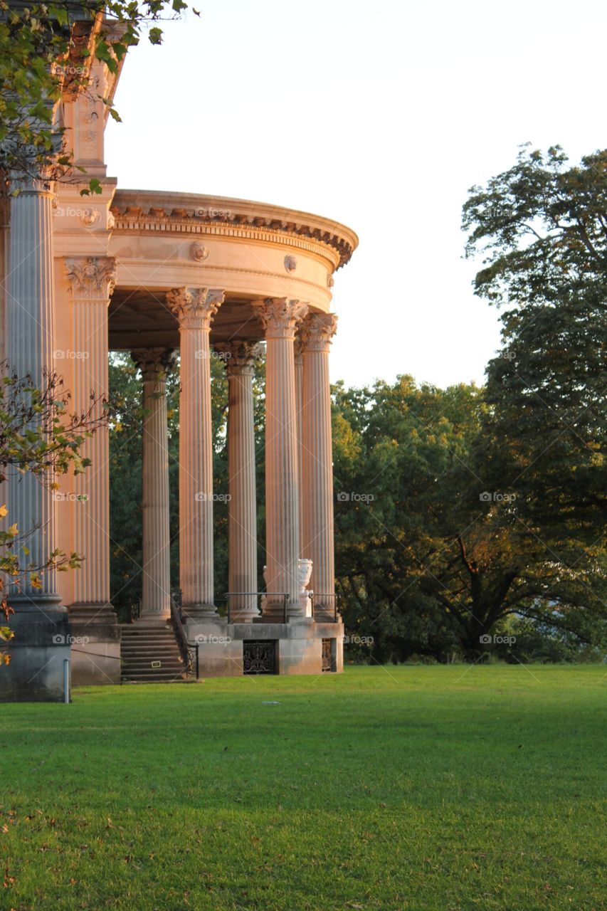 Autumn light . Just before sunset,  rays of sun highlight the mansion and surrounding foliage
